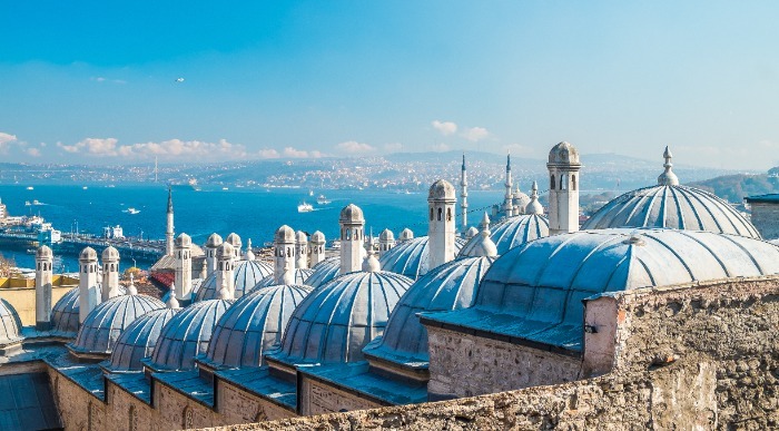 Strehe mošej v Istanbulu s pogledom na modrino neba in morja. 
